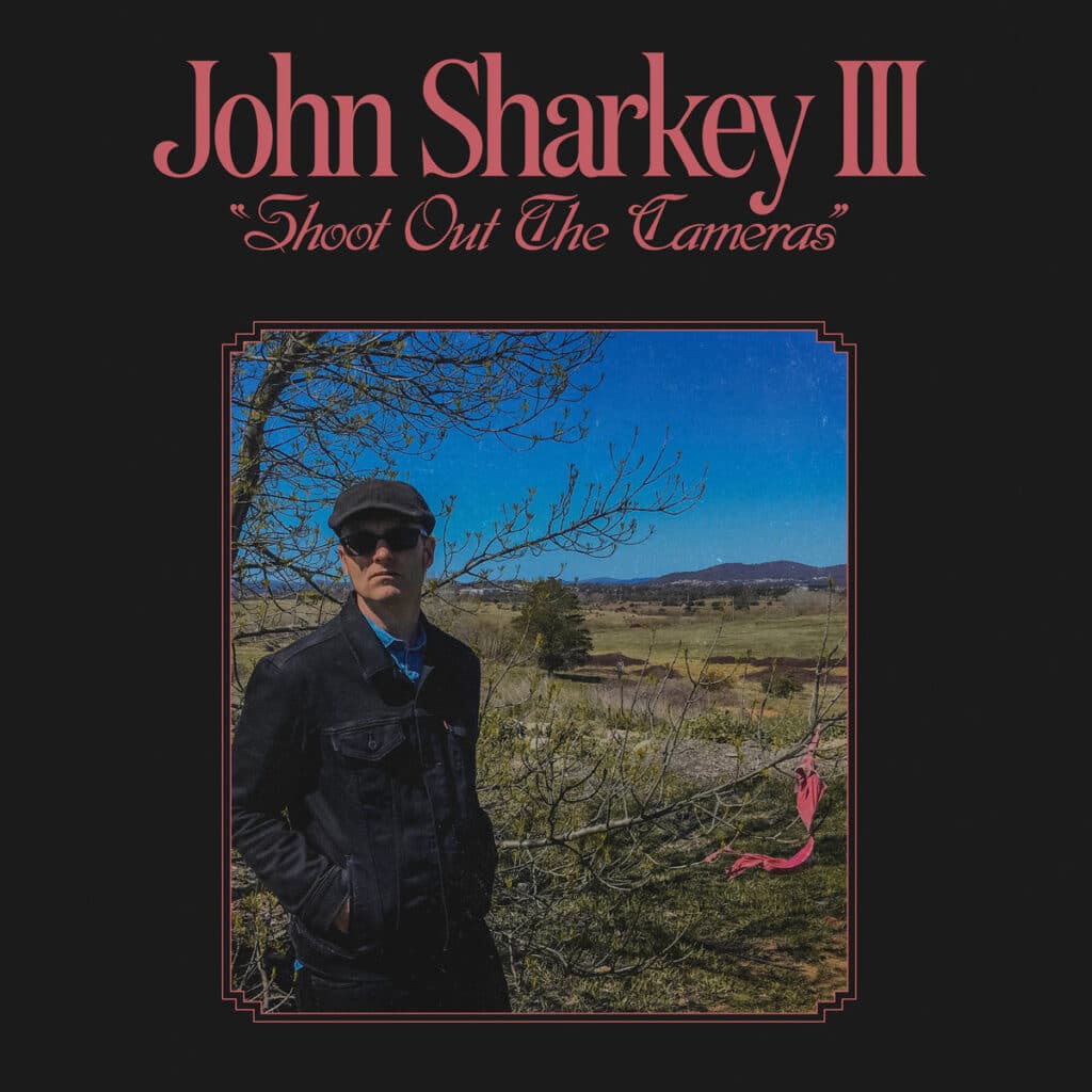 Cover art for Shoot out the Cameras by John Sharkey. Full record & mix: Infidel Studios
